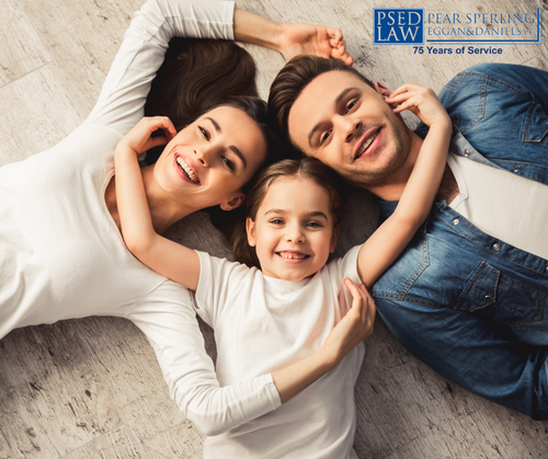 Happy family smiling laying on the floor in a circle