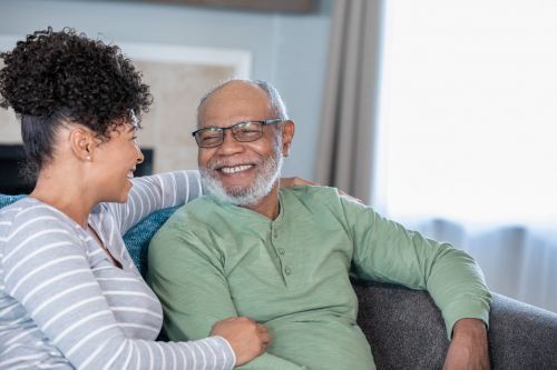 a daughter visiting her dad smiling
