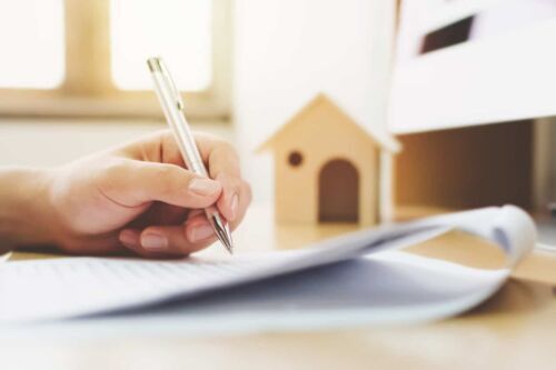 signing paperwork with a pen