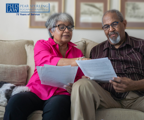 an older couple reading over documents to review their estate plans